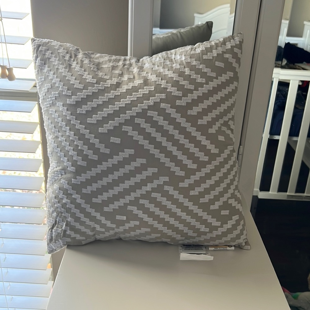 Gray and white decorative pillow